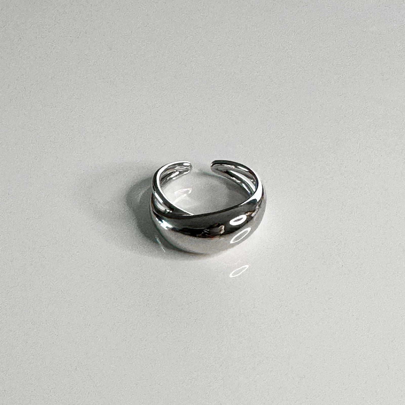 Front view of rhodium plated sterling silver dome cut out ring