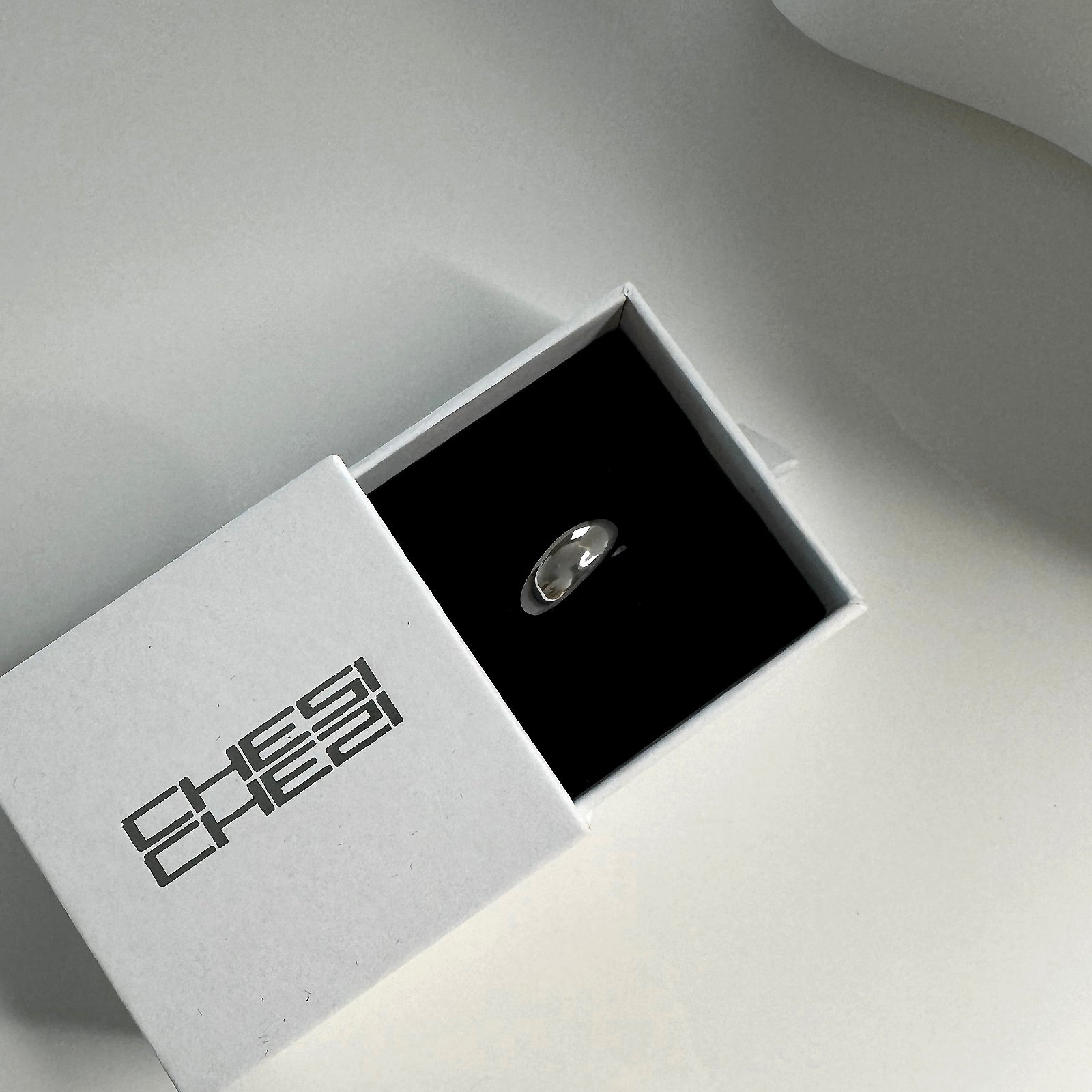 Adjustable CHESI Dome Cut Out Ring in 925 sterling silver with rhodium plating, displayed in CHESI branded gift box.
