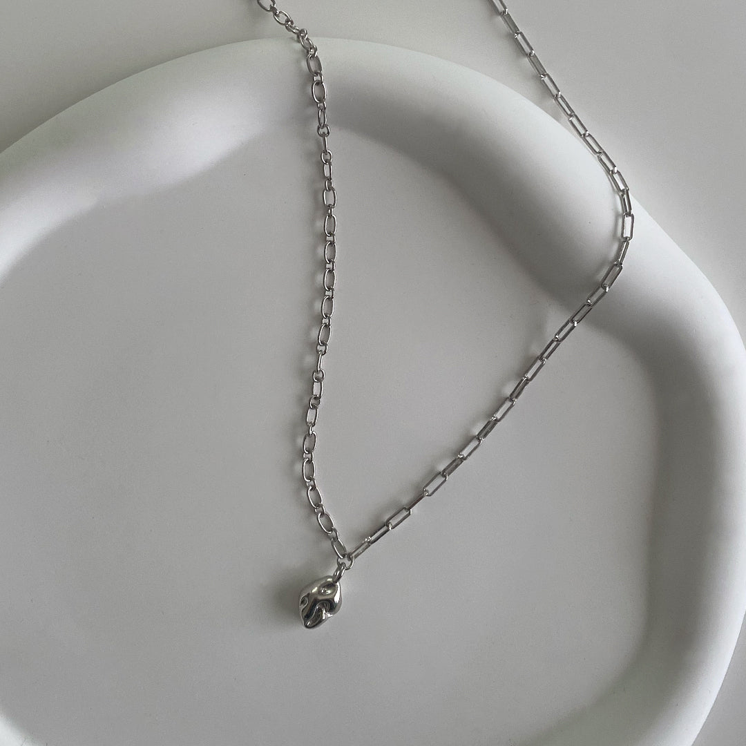 CHESI 925 sterling silver Half and Half Pendant Necklace with rhodium plating, close-up showing pendant and chain details on white tray.