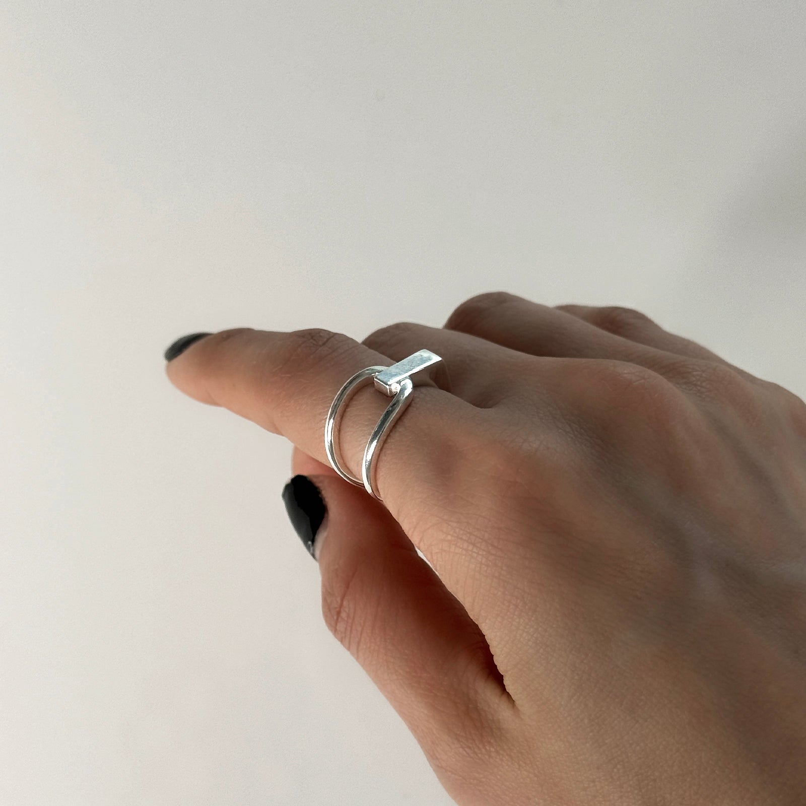 CHESI 925 sterling silver adjustable Interloop Ring worn on female model's hand.