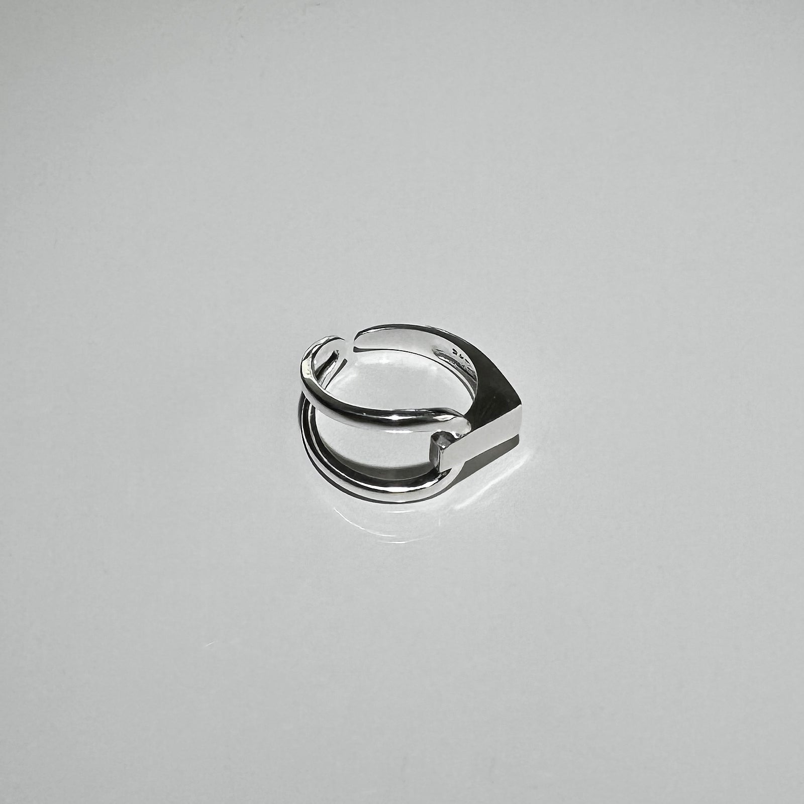Side angle view of CHESI 925 sterling silver adjustable Interloop Ring