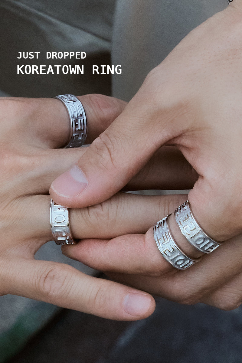 Close-up of male model’s hands wearing multiple CHESI 925 sterling silver Koreatown rings.