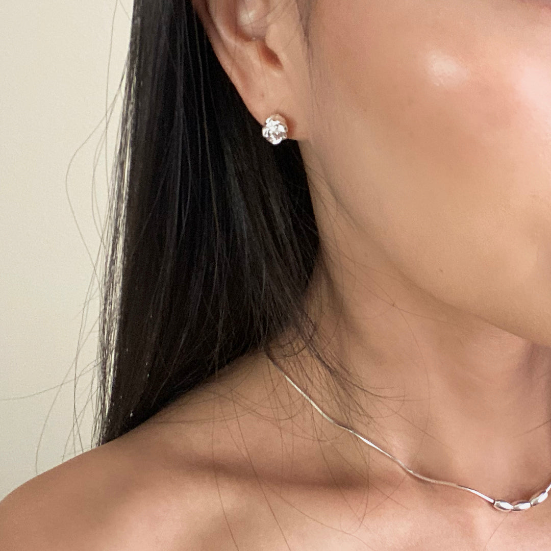 Model wearing CHESI 925 sterling silver Rosy Studs paired with Triple Charm Necklace.