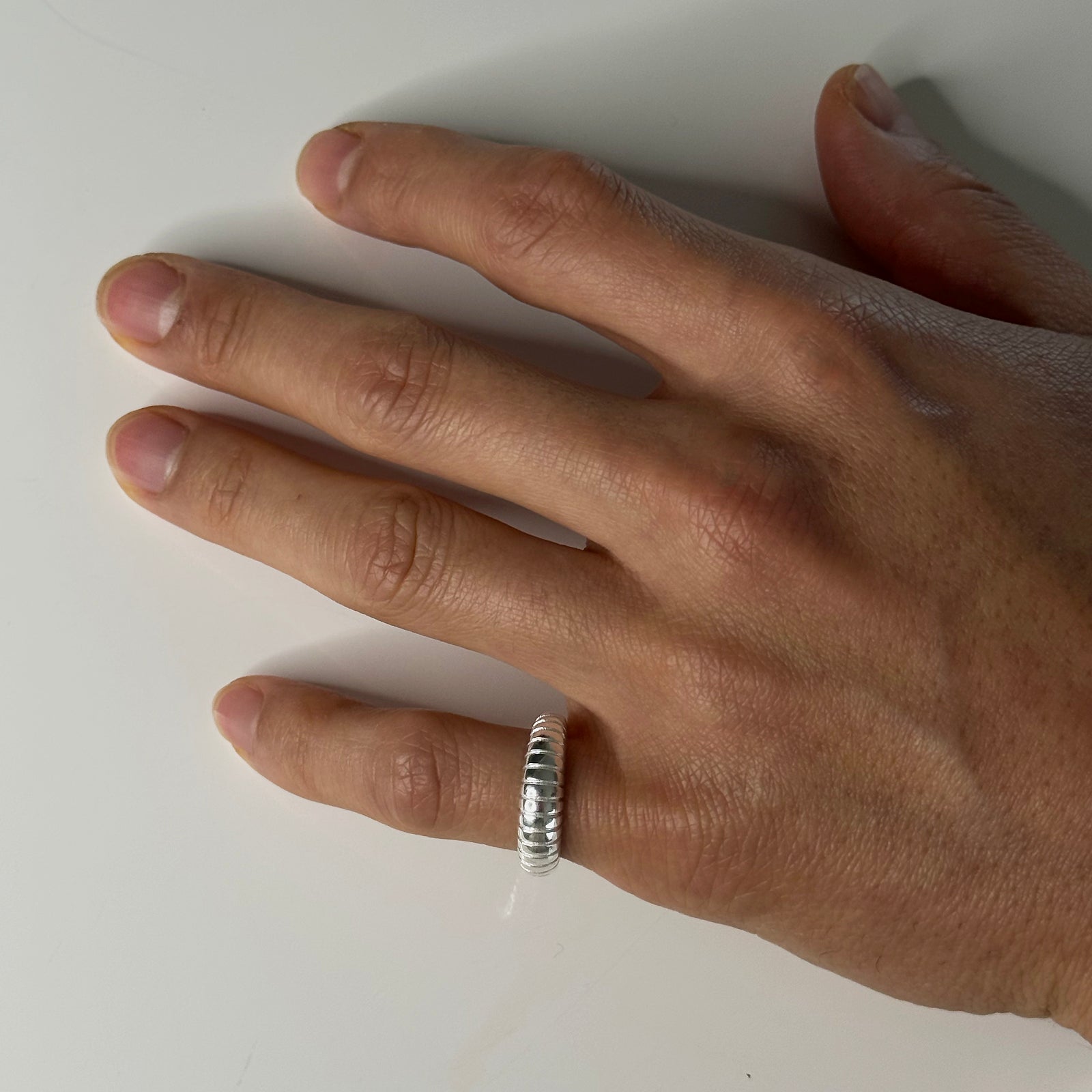 CHESI 925 sterling silver adjustable Textured Band worn on male model’s pinky finger.