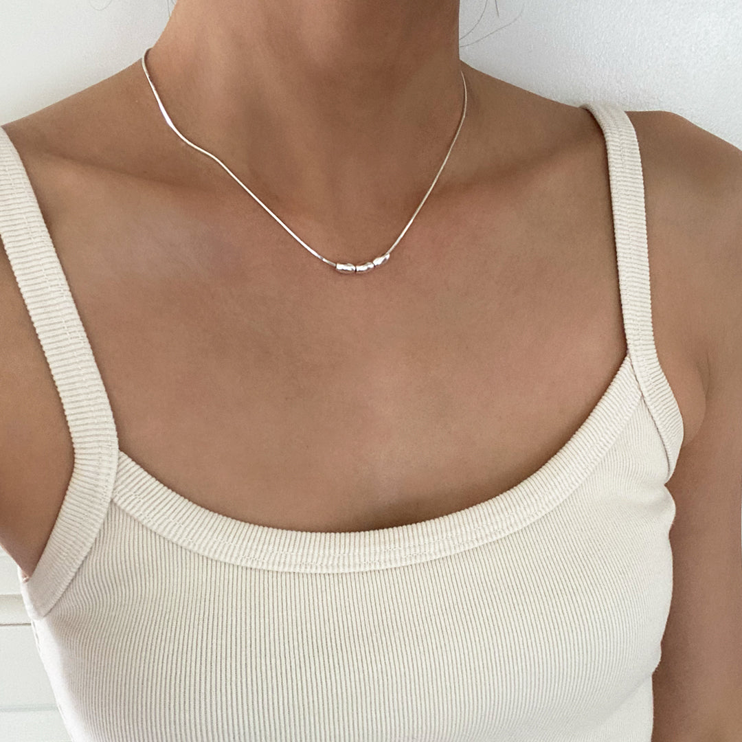CHESI 925 sterling silver Triple Charm Necklace worn by model, front view.