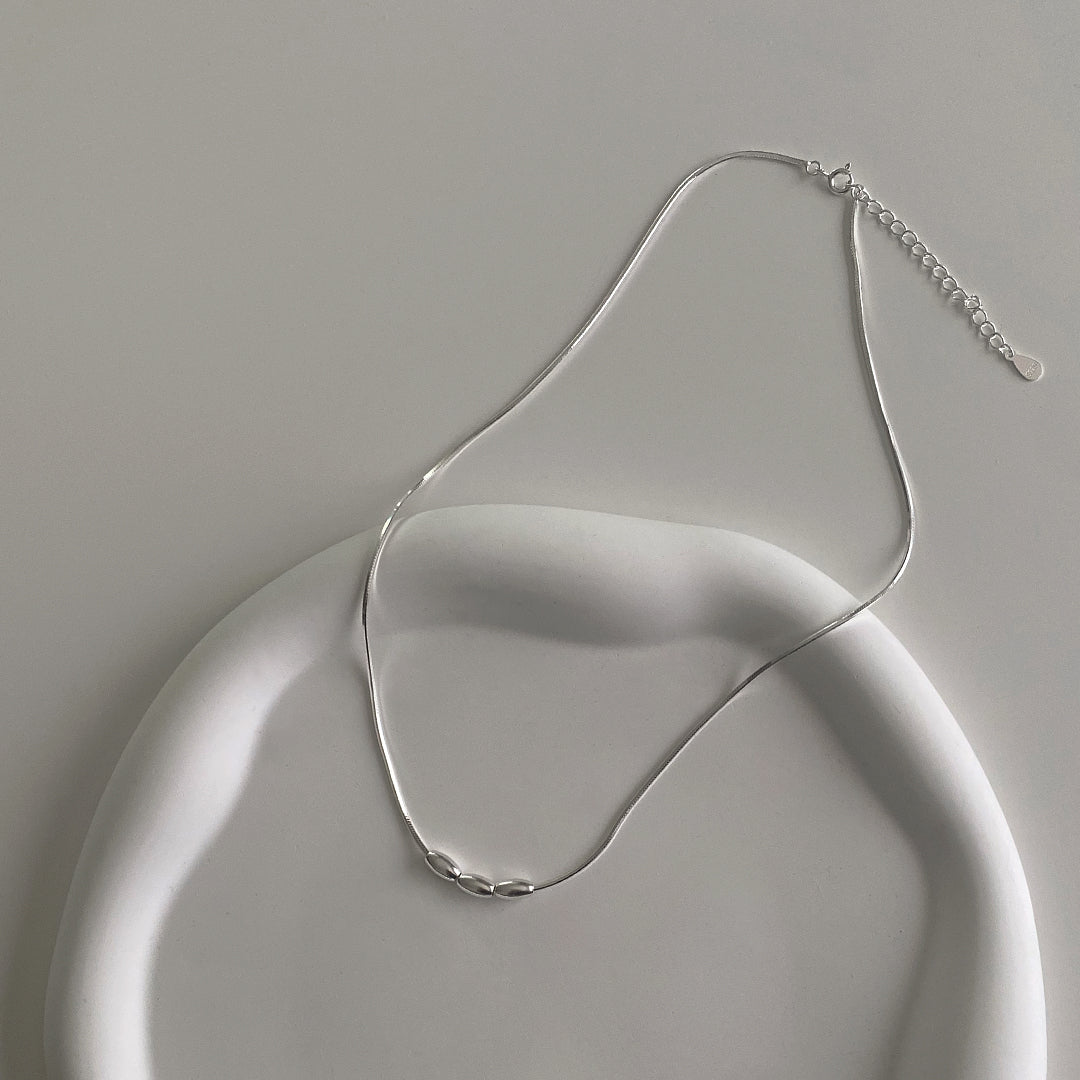 CHESI Triple Charm Necklace in 925 sterling silver, top view with adjustable chain details.