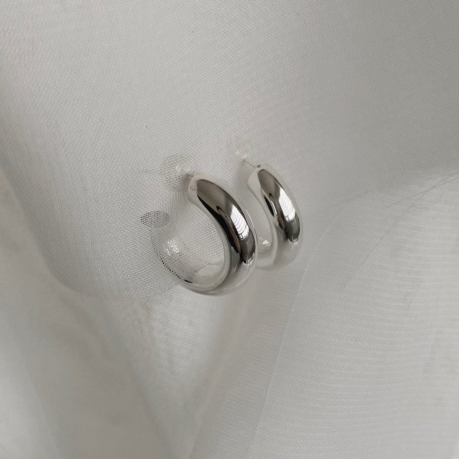 Top view of the Hollow Tube Hoops. These hoop earrings are made of 925 sterling silver with a push back for closure. These earrings are lightweight and hollow.