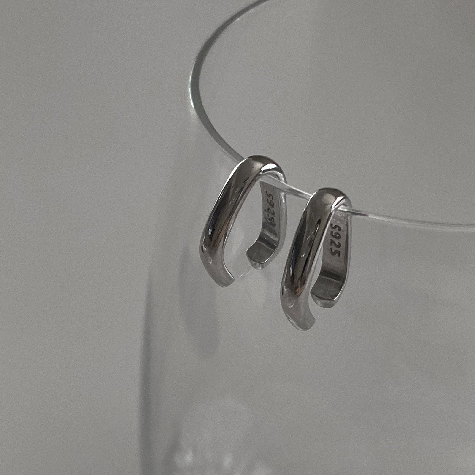 Close up side view of our Minimal Ear Cuff Set in Silver. The image shows our genuine S925 silver stamp.