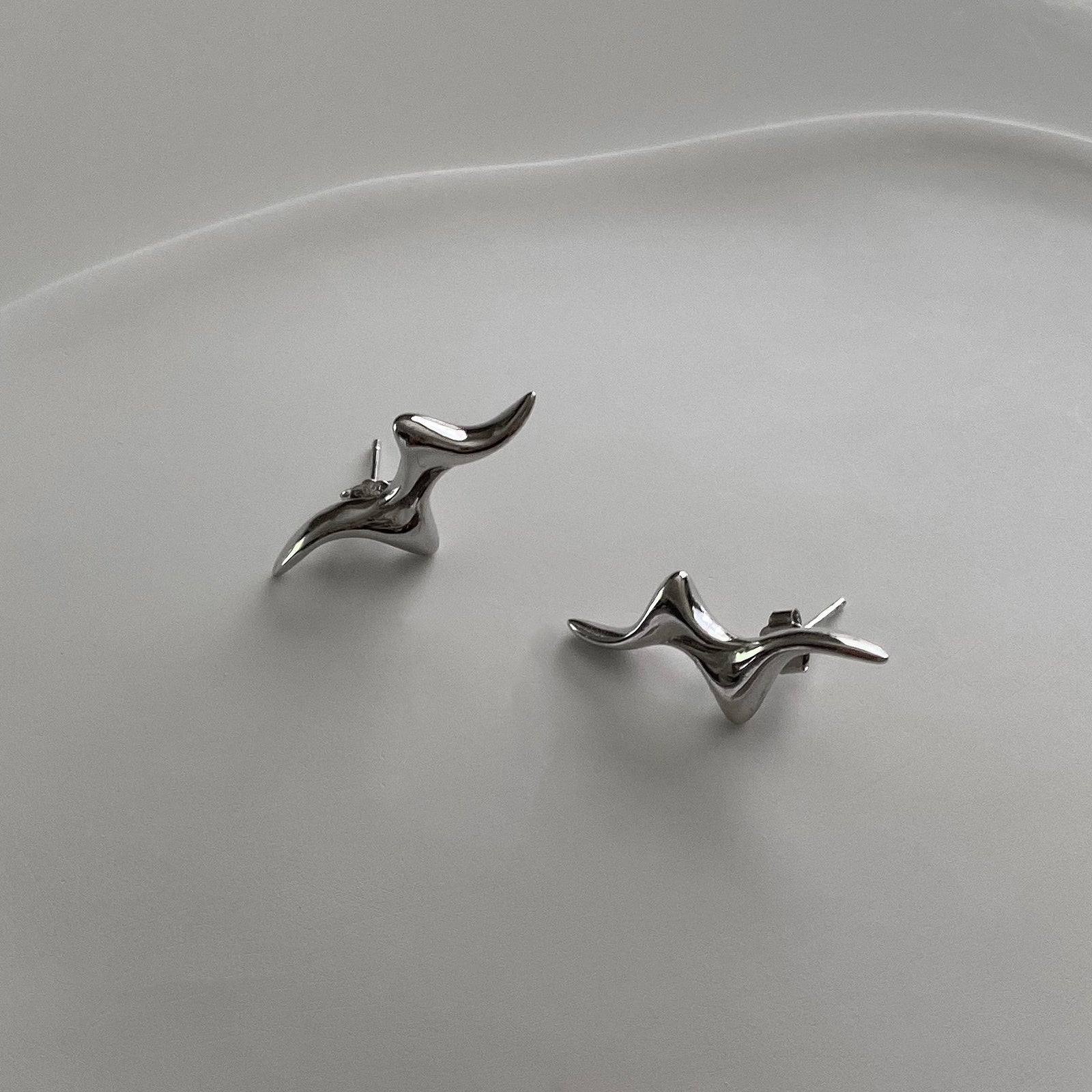 A close up of our Swirly Bolt Studs. These earrings have a cool wavy-like design.